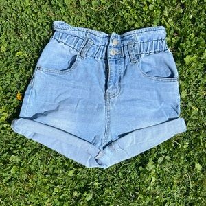 high waisted, light blue denim shorts with elastic waistband, zipper closure